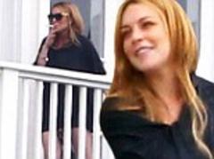 Lindsay Lohan looks happy and relaxed as she smokes a cigarette with her new friends at rehab